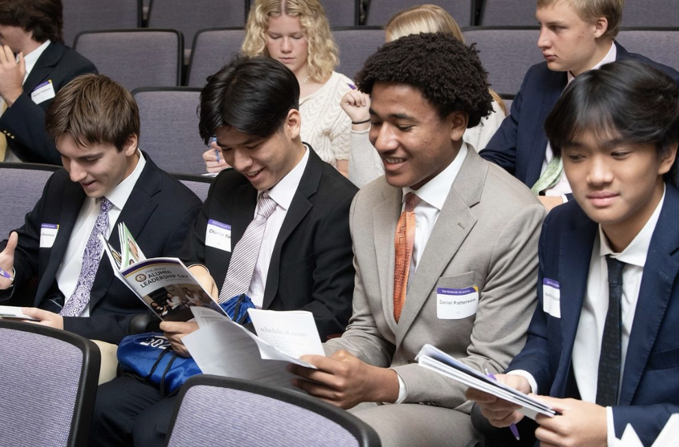 Seniors Charlie Yang, Harrison Nguyen, Daniel Patterson, and Timur Balametov eagerly look at the list of speakers for their upcoming Banking, Finance, and Accounting panel.